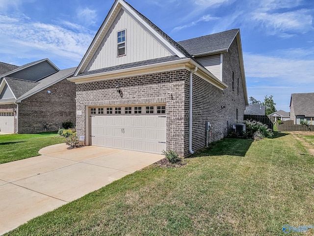 view of front of house featuring a garage, central AC unit, and a front lawn