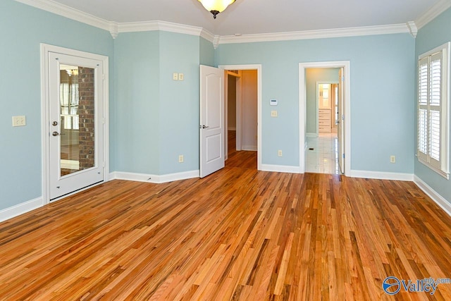 unfurnished bedroom with crown molding, baseboards, and wood finished floors