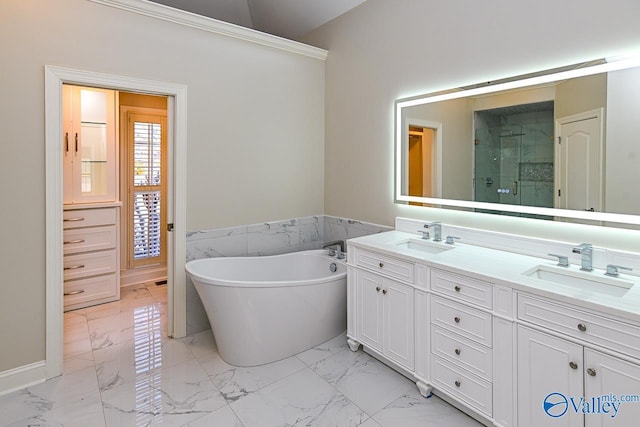 bathroom featuring marble finish floor, a sink, a shower stall, and a freestanding bath