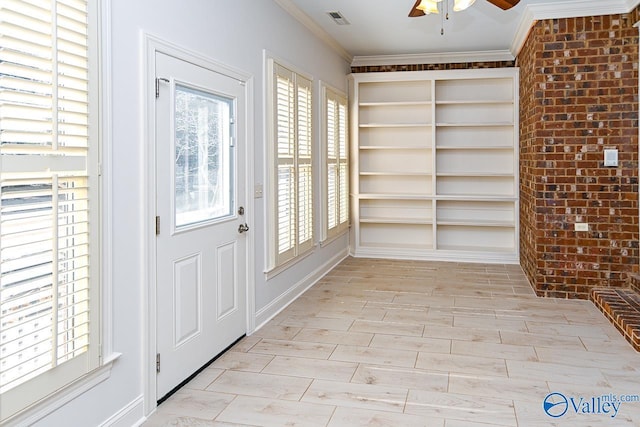 interior space featuring brick wall, visible vents, ornamental molding, and wood finish floors