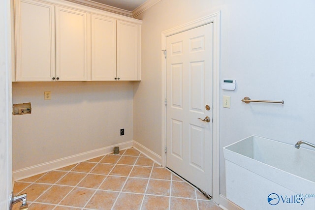 laundry area with cabinet space, light tile patterned floors, baseboards, hookup for a washing machine, and crown molding