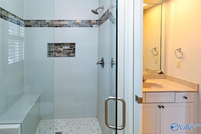 full bath featuring a stall shower and vanity