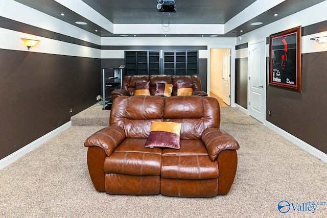 cinema room featuring a raised ceiling, recessed lighting, carpet flooring, and baseboards