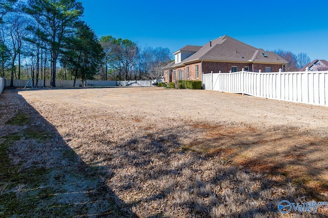 view of yard with a fenced backyard