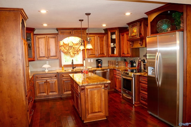 kitchen with light stone counters, stainless steel appliances, dark wood-type flooring, and a sink