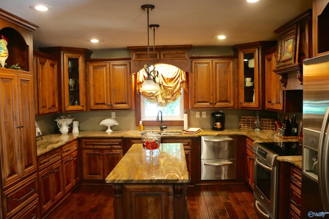 kitchen featuring dark wood finished floors, light stone counters, recessed lighting, appliances with stainless steel finishes, and a sink