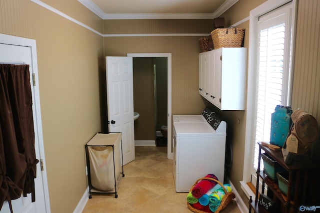 laundry room featuring cabinet space, baseboards, ornamental molding, and separate washer and dryer