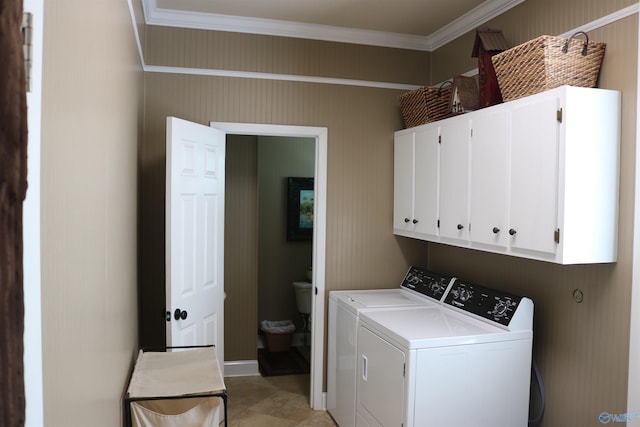 laundry area with washer and dryer, cabinet space, and ornamental molding