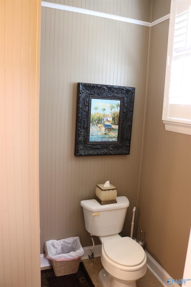 bathroom with baseboards and toilet