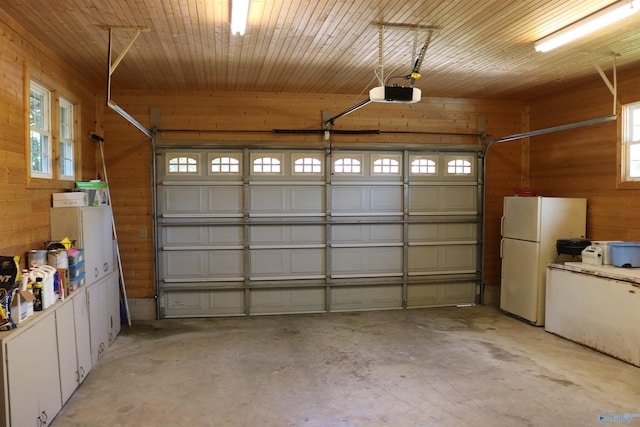 garage with wood ceiling, a garage door opener, wood walls, and freestanding refrigerator