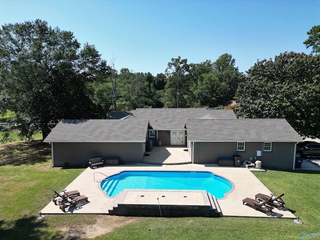 pool with a yard and a patio area