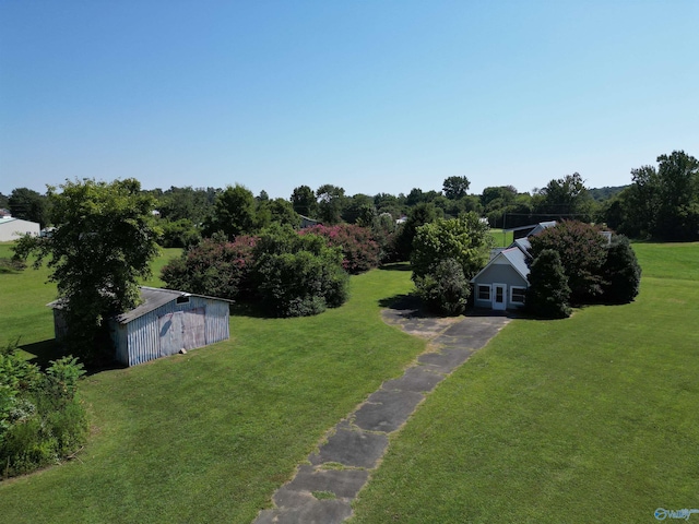 view of yard featuring an outbuilding, an outdoor structure, and driveway