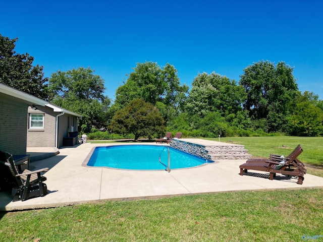 outdoor pool featuring a patio area and a lawn