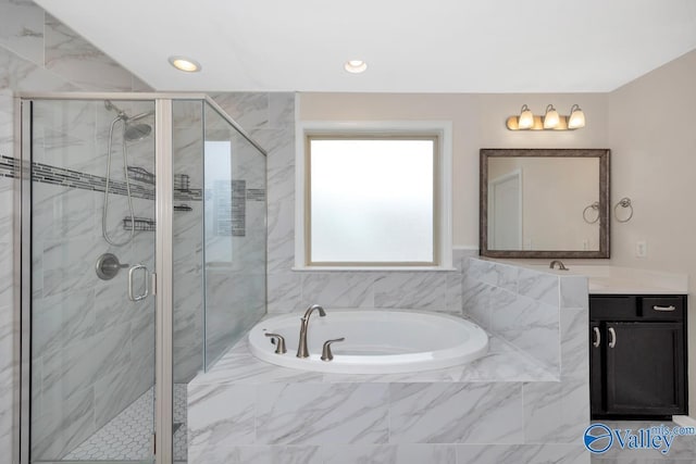 217 Skehan St SW, Huntsville, AL 35824 - full bath featuring a bath, vanity, a stall shower, and recessed lighting