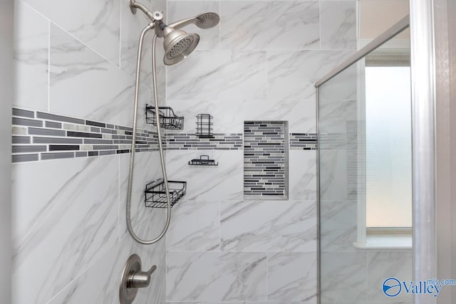 bathroom with tiled shower