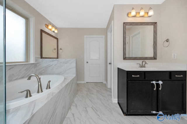 bathroom featuring vanity, tiled bath, and plenty of natural light