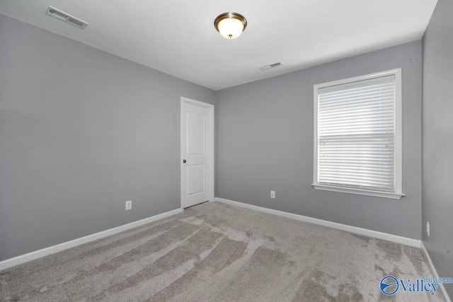 unfurnished room with light colored carpet