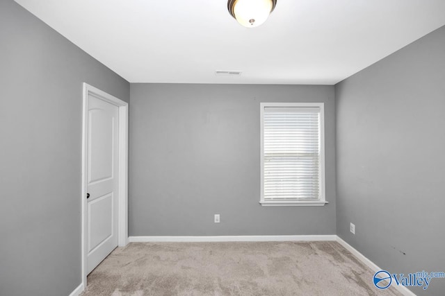 empty room with light colored carpet