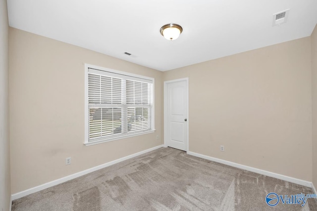 empty room featuring light colored carpet