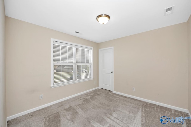 217 Skehan St SW, Huntsville, AL 35824 - spare room featuring baseboards and carpet floors