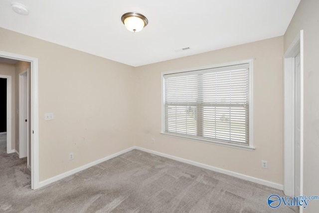 217 Skehan St SW, Huntsville, AL 35824 - empty room featuring carpet flooring and a smoke detector