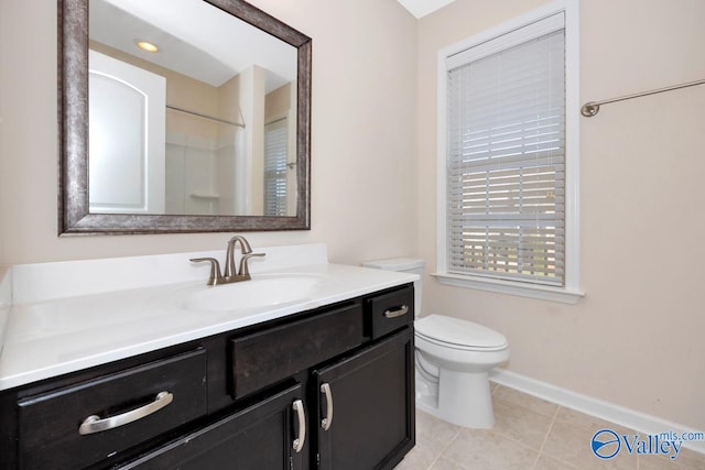 bathroom with toilet, vanity, tile patterned floors, and a shower