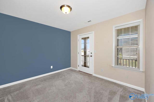 spare room with light colored carpet