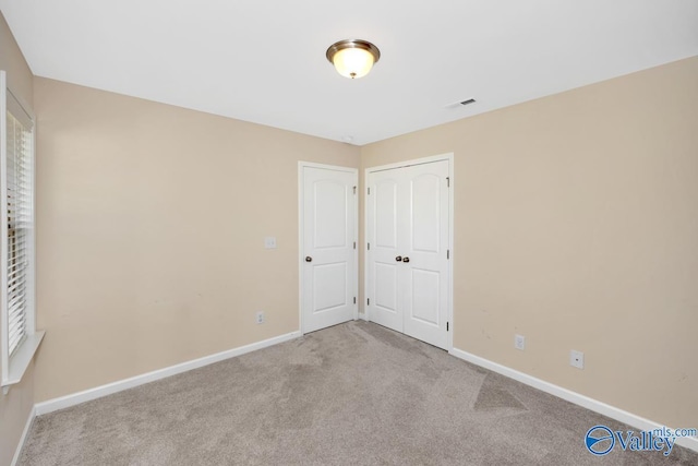 217 Skehan St SW, Huntsville, AL 35824 - unfurnished bedroom featuring carpet and a closet