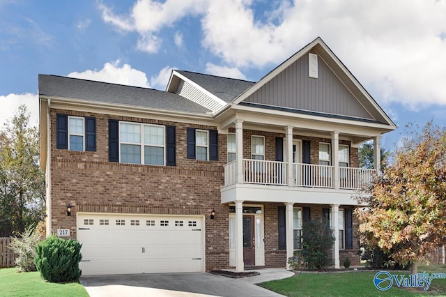 view of front facade featuring a garage, a front lawn, and a balcony