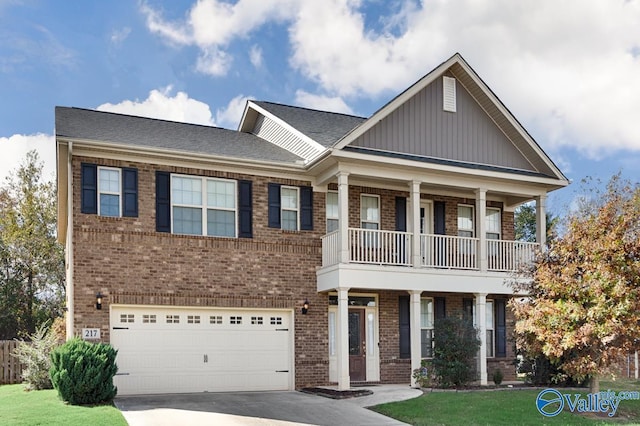 217 Skehan St SW, Huntsville, AL 35824 - craftsman-style house featuring brick siding, an attached garage, a balcony, driveway, and board and batten siding