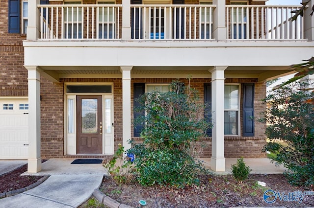 217 Skehan St SW, Huntsville, AL 35824 - view of exterior entry featuring brick siding, a balcony, and a porch