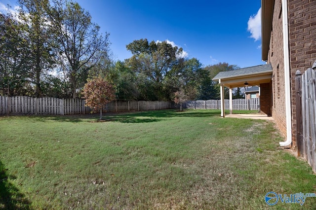 217 Skehan St SW, Huntsville, AL 35824 - fenced backyard featuring a ceiling fan and a patio area