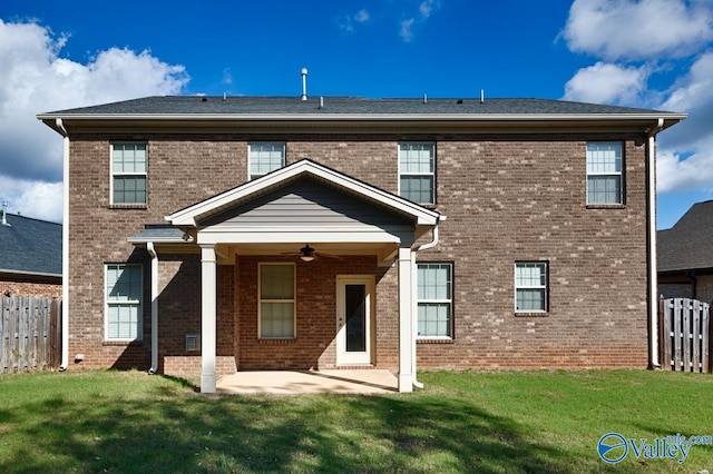 rear view of property with a patio, a lawn, and ceiling fan