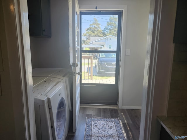 washroom with independent washer and dryer, baseboards, laundry area, and wood finished floors