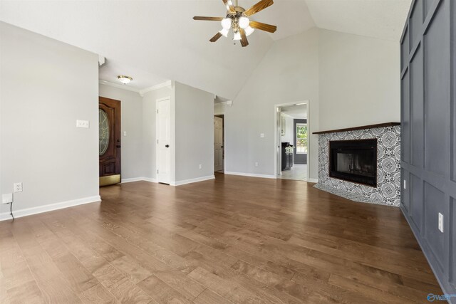 123 Turtle Ridge Dr, New Market, AL 35761 - unfurnished living room featuring a ceiling fan, wood finished floors, a tile fireplace, baseboards, and high vaulted ceiling