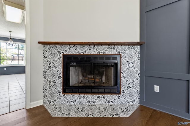 123 Turtle Ridge Dr, New Market, AL 35761 - detailed view of a tile fireplace, wood finished floors, and baseboards