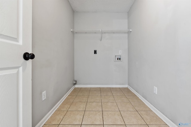 123 Turtle Ridge Dr, New Market, AL 35761 - washroom featuring hookup for an electric dryer, washer hookup, light tile patterned floors, baseboards, and a textured ceiling