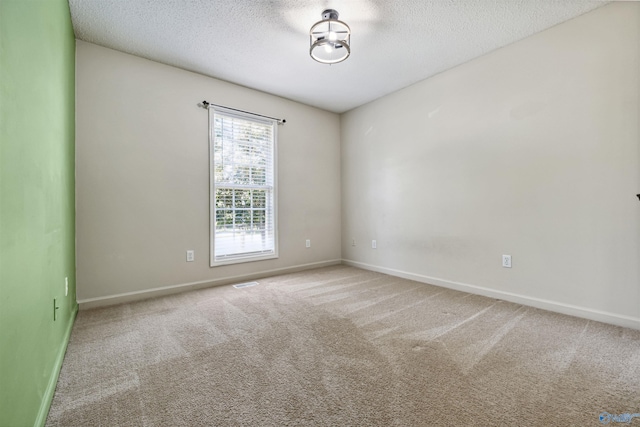 123 Turtle Ridge Dr, New Market, AL 35761 - empty room featuring a textured ceiling, carpet flooring, and baseboards
