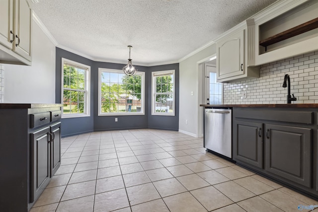 123 Turtle Ridge Dr, New Market, AL 35761 - kitchen with stainless steel dishwasher, decorative backsplash, a textured ceiling, crown molding, and light tile patterned floors