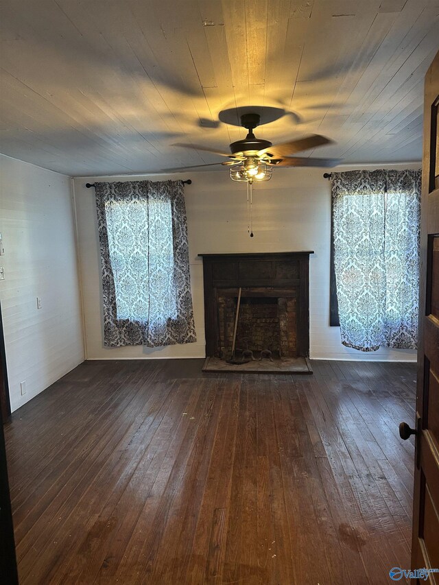 unfurnished living room featuring ceiling fan and dark wood-type flooring