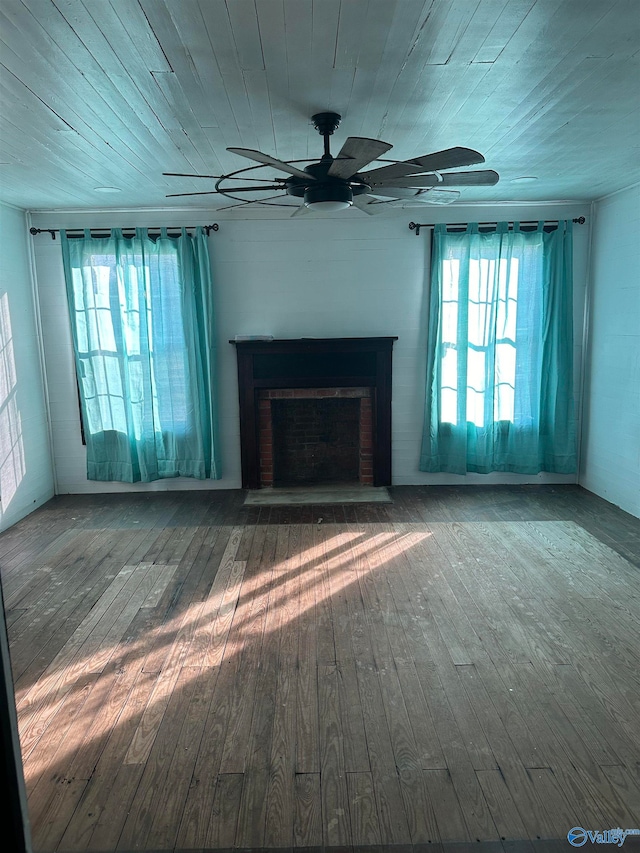 unfurnished living room featuring a brick fireplace, hardwood / wood-style floors, and wood ceiling