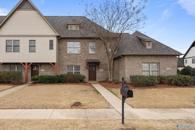 multi unit property with brick siding and roof with shingles