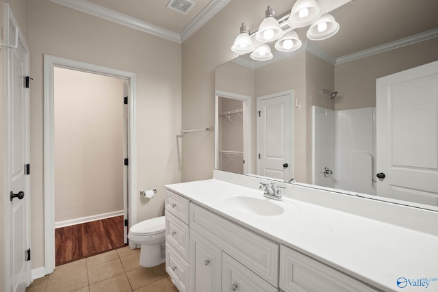 full bath featuring crown molding, visible vents, toilet, vanity, and tile patterned floors