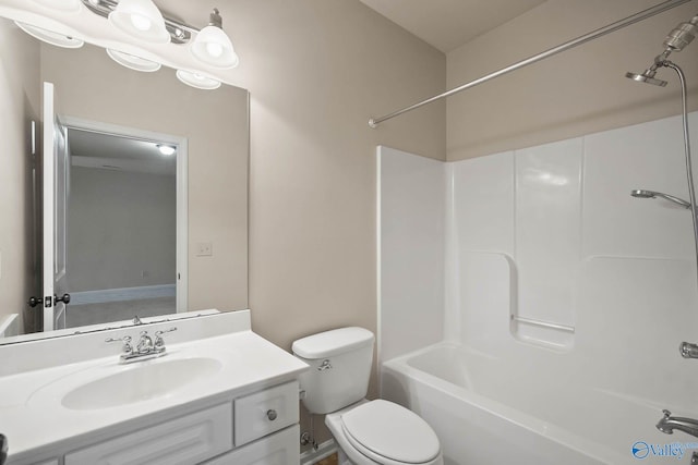 bathroom with bathtub / shower combination, vanity, and toilet