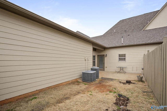 back of property with central AC unit, a patio area, and fence