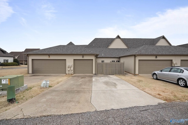 view of front of house with a garage and roof with shingles