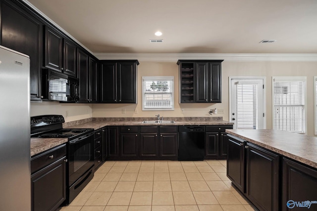 kitchen featuring black appliances, dark cabinetry, a sink, and visible vents