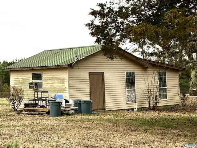 back of property with metal roof and cooling unit