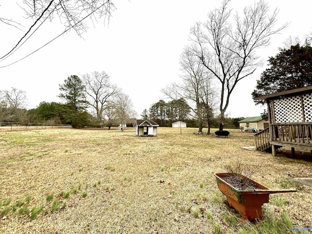 view of yard featuring a garden, an outdoor structure, and a storage shed