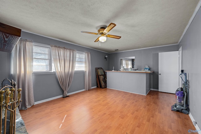 interior space featuring a textured ceiling, hardwood / wood-style flooring, ceiling fan, and ornamental molding